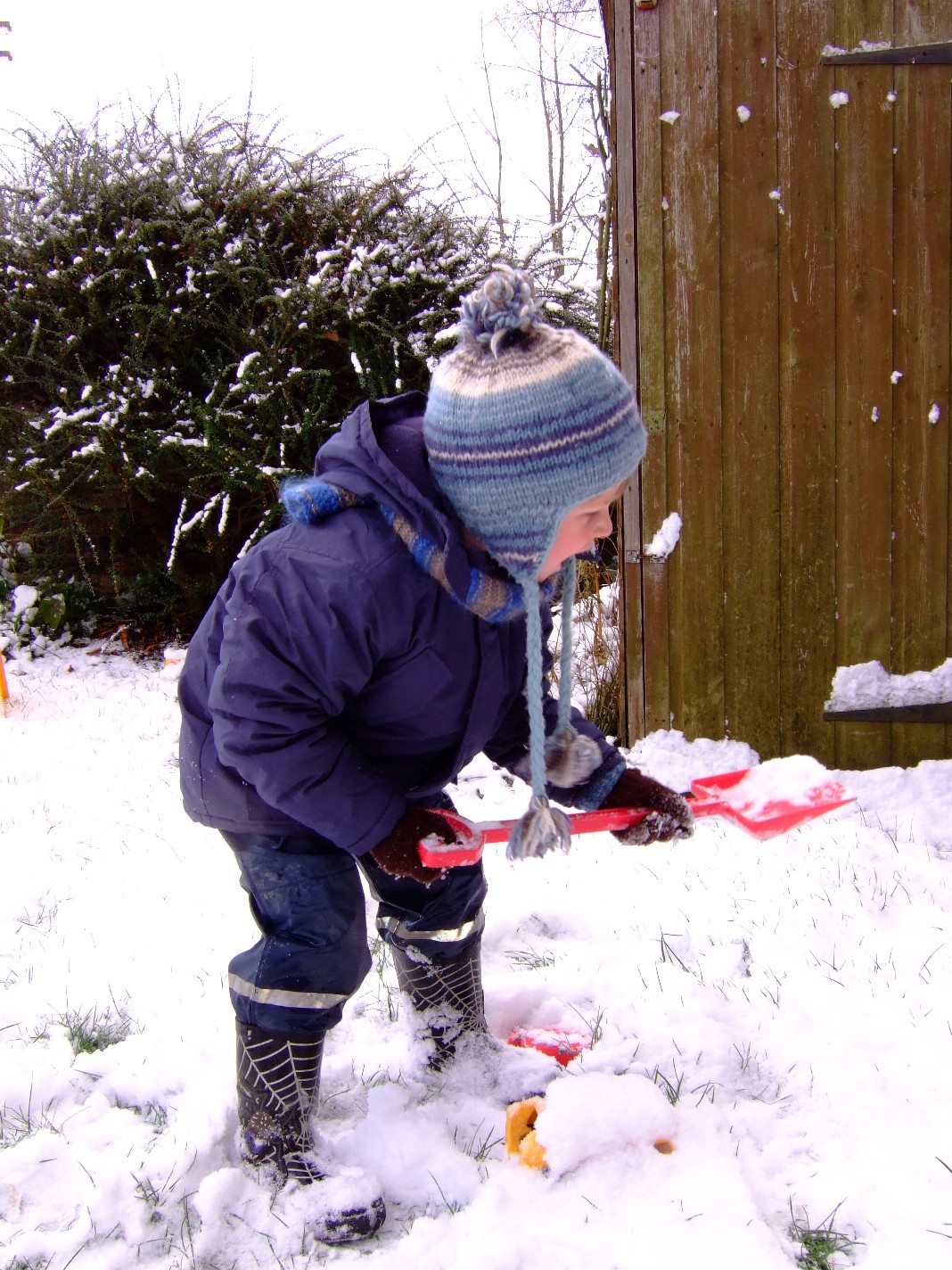 In the garden outside our house in Edinburgh, Thomas shoveling the  first snow of 2010
